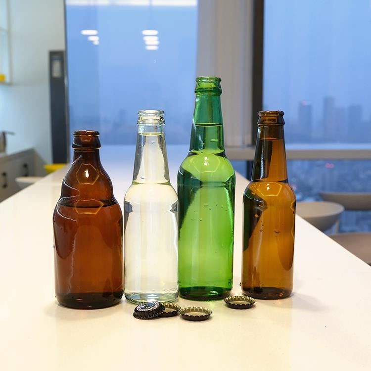 Bière vert ambrée de haute qualité Bouteille en verre Bière à étiquette chaude claire