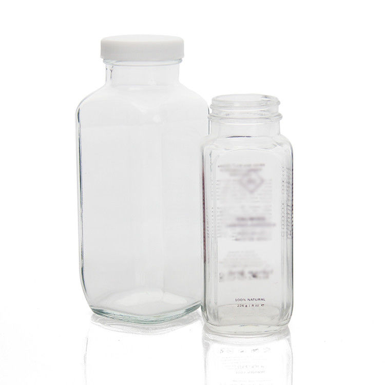 Bouteilles de jus en verre Bouteilles de jus en verre carrées avec un bouchon anti-altération pour l'emballage des boissons au jus
