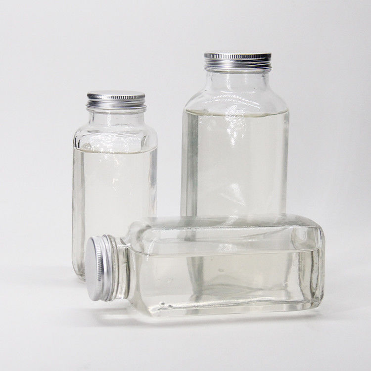 Bouteilles de jus en verre Bouteilles de jus en verre carrées avec un bouchon anti-altération pour l'emballage des boissons au jus